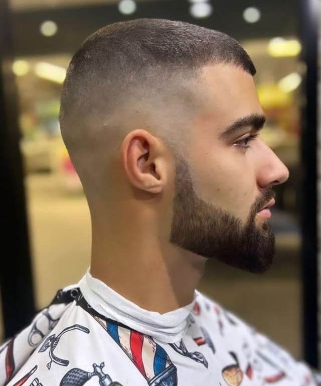 Skin fade paired with a shaped beard, viewed in profile