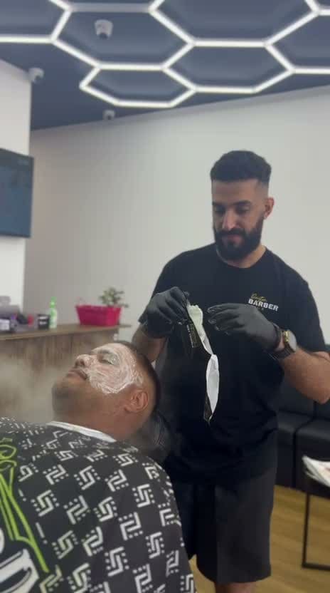 Black mask facial treatment applied to a reclined client