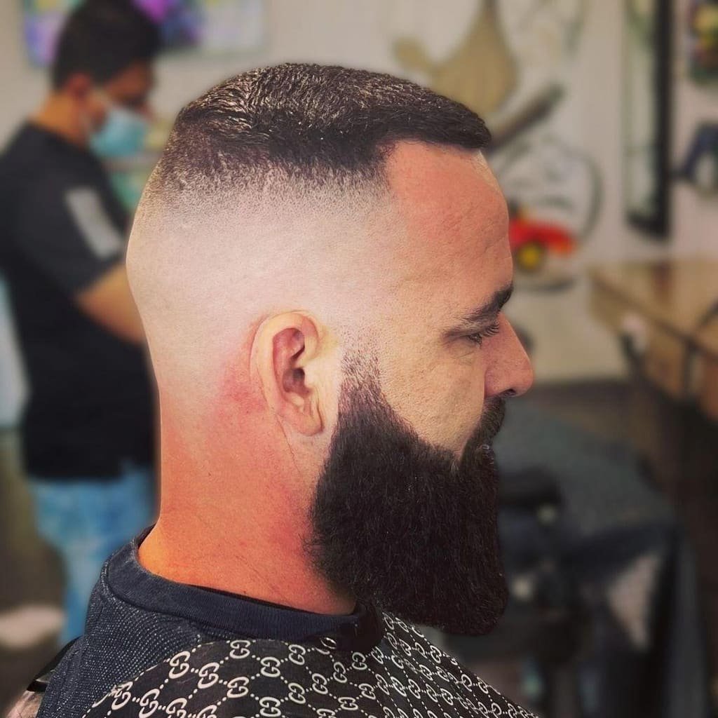 Full-length beard shaped and paired with a skin fade